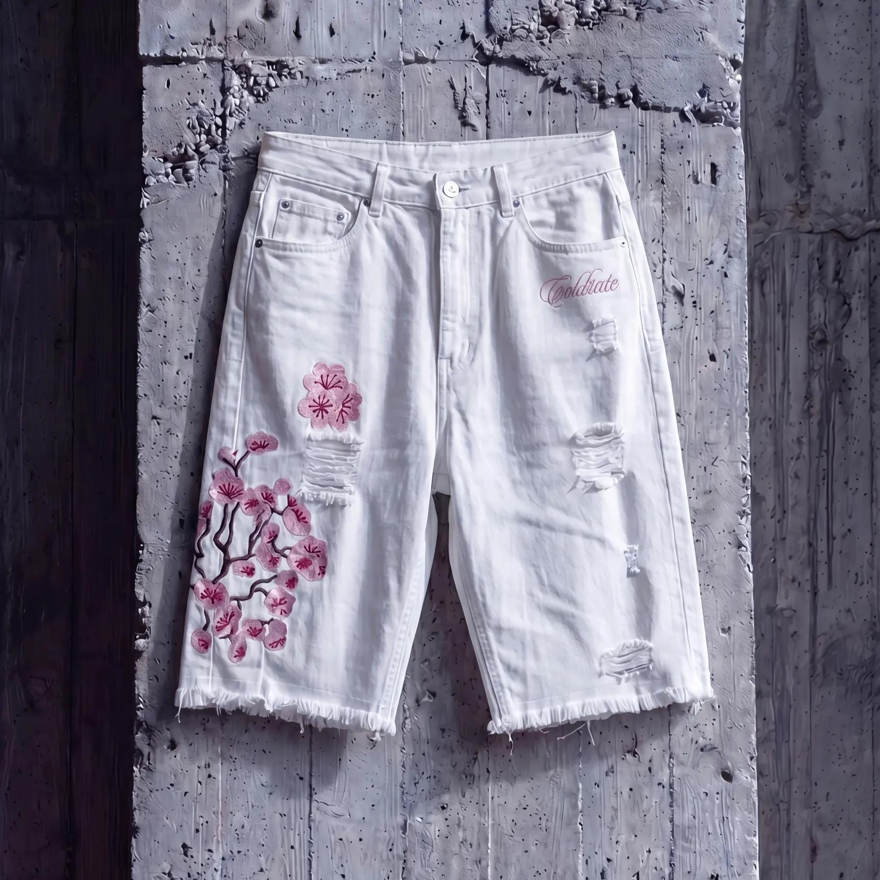 White cutoff shorts with pink floral embroidery