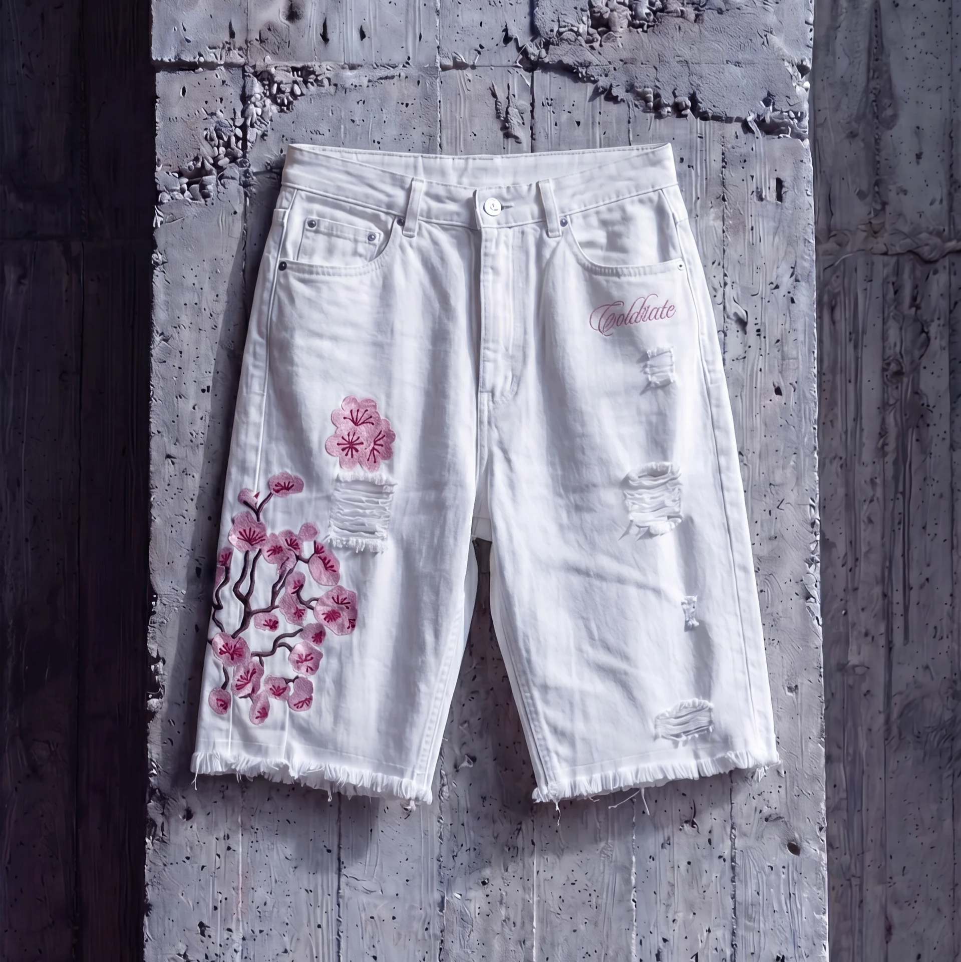 White cutoff shorts with pink floral embroidery
