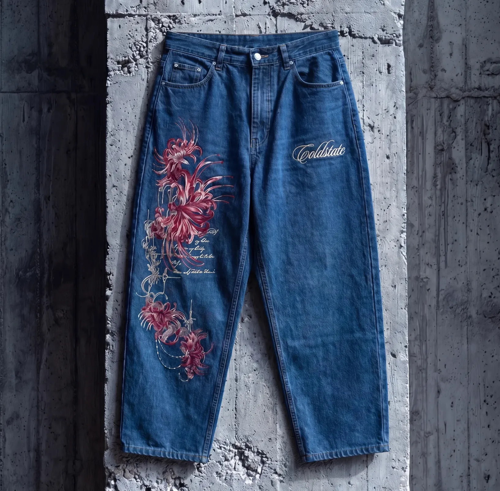 Blue denim jeans with red floral artwork and Cold State script