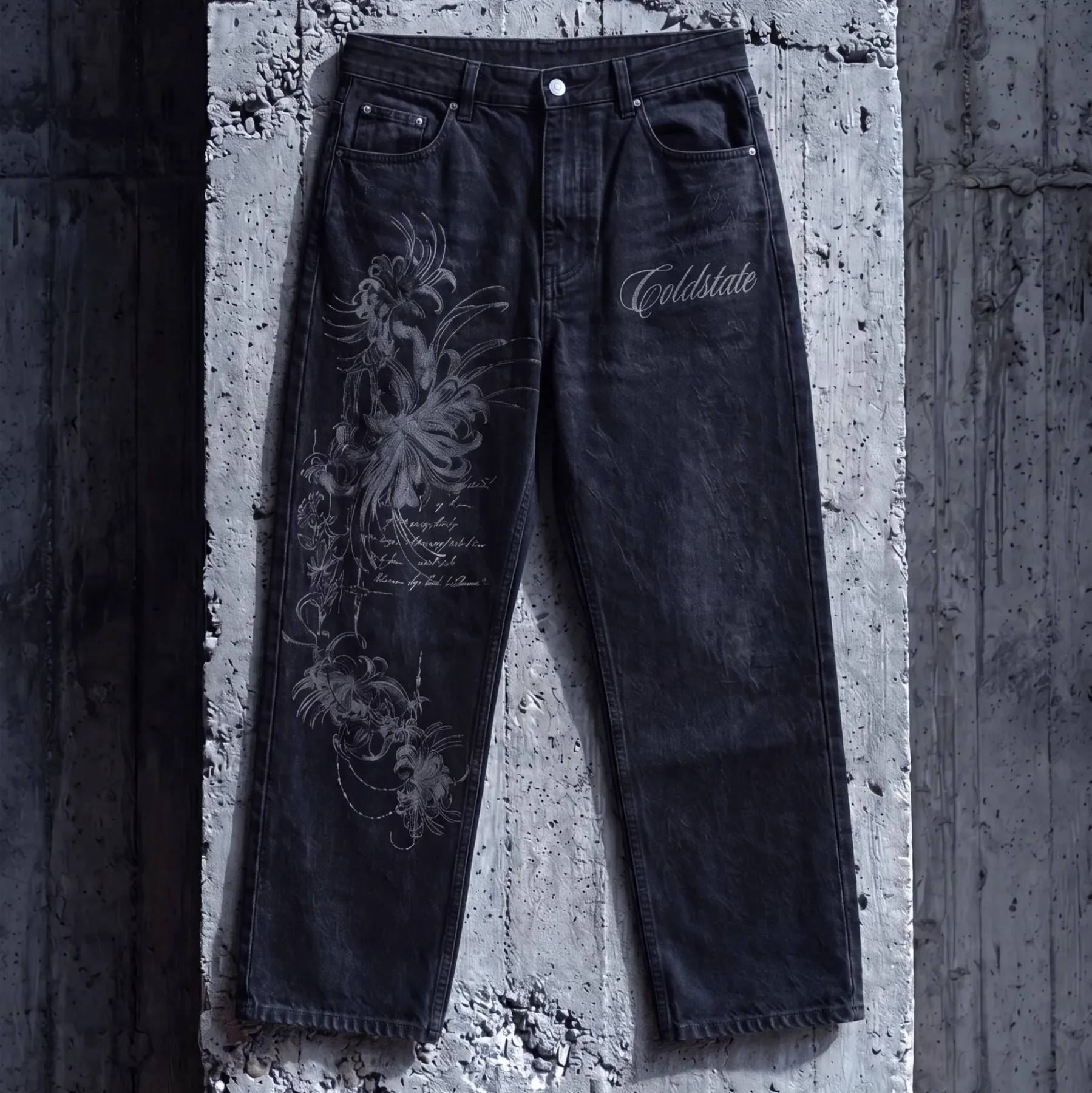Black washed denim jeans with tonal floral artwork and Cold State script